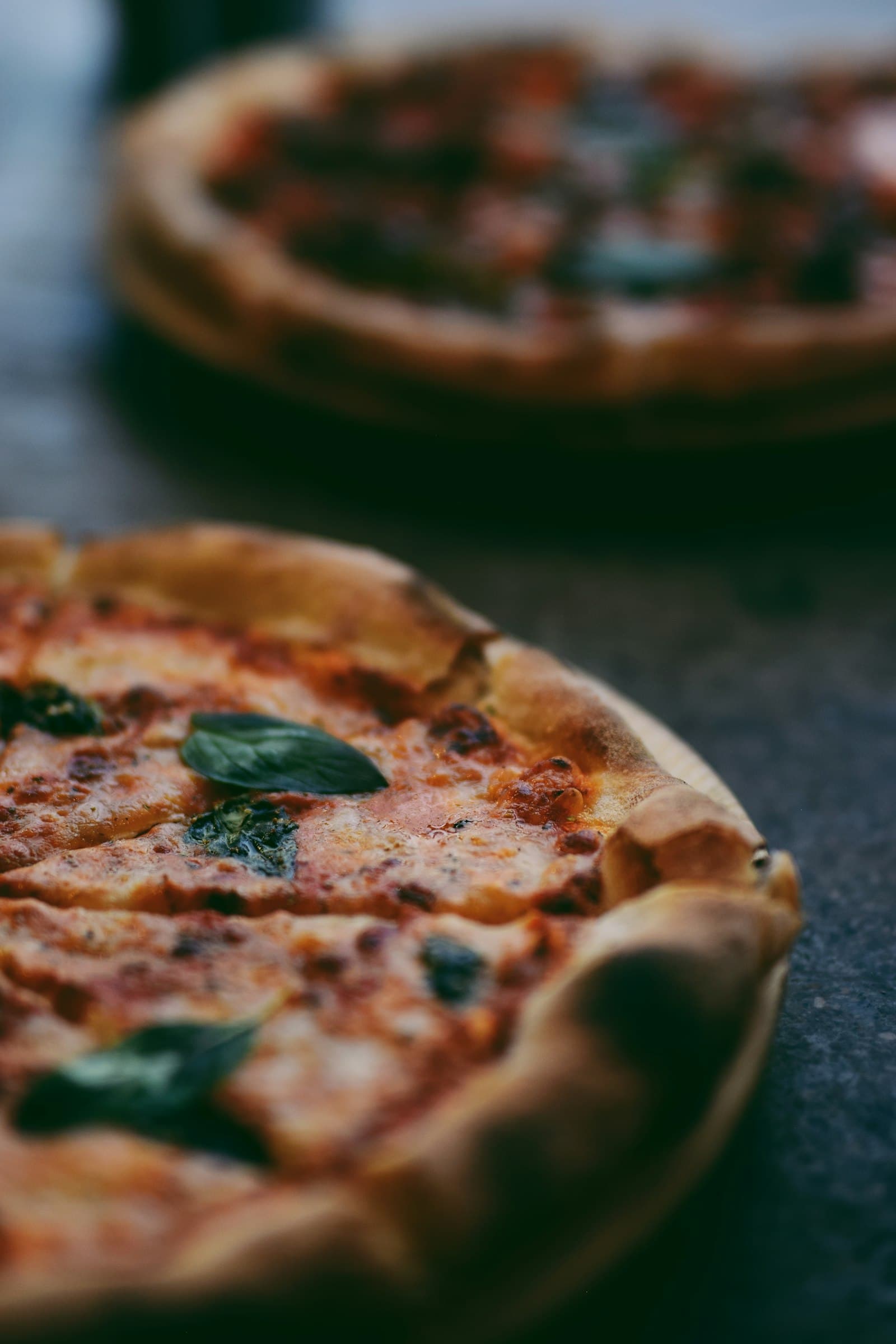 Freshly baked pizza with melted mozzarella and basil, straight from the oven